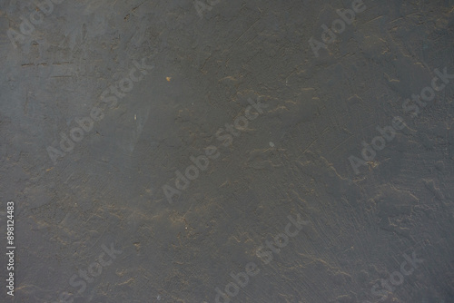 dusty and weathered dark grey painted wall texture photo