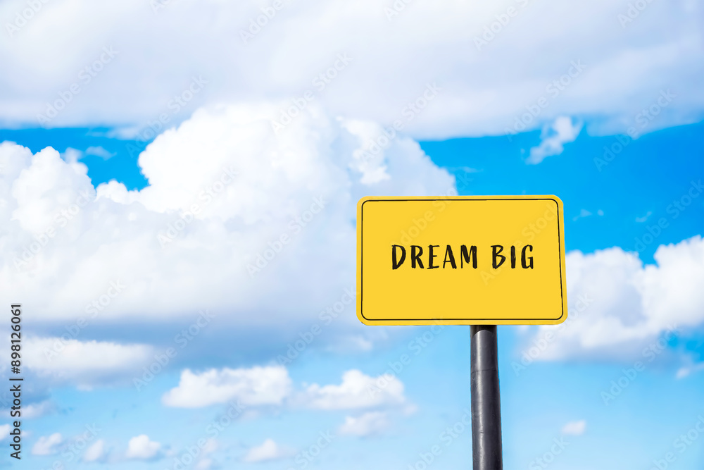 Yellow Sign with Dream Big Message Against Blue Sky Yellow Sign with Dream Big Message Against Blue Sky