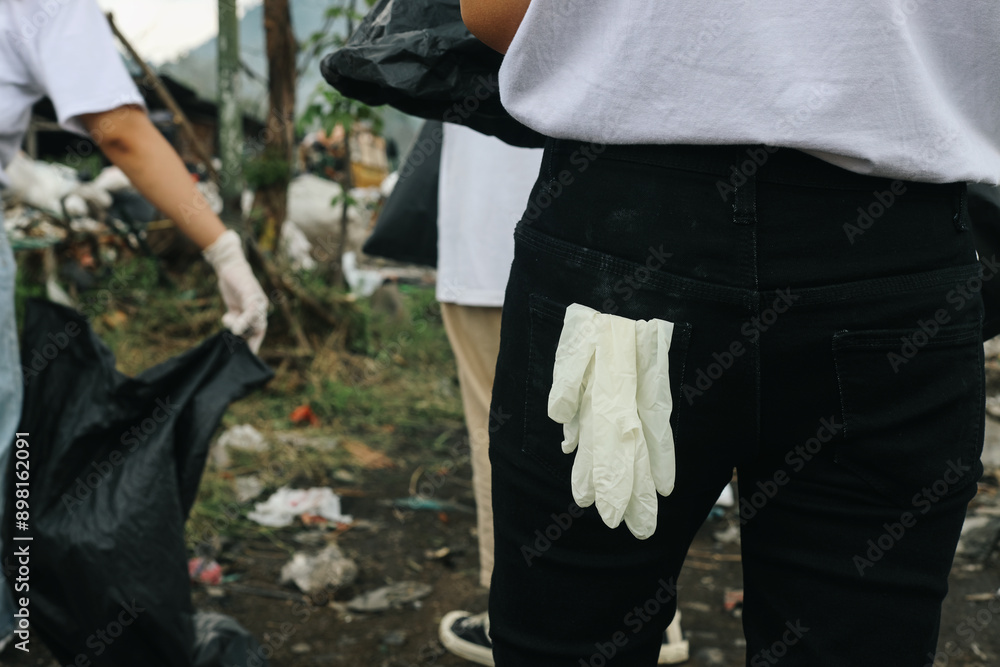 Work Gloves In The Back Pocket Of Pants. Volunteering, Charity, Cleaning, People And Ecology Concept. Work Gloves In The Back Pocket Of Pants. Volunteering, Charity, Cleaning, People And Ecology Concept.