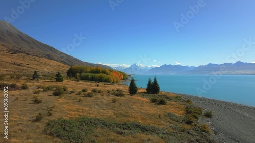 Lake Pukaki on the South Island of New Zealand - pullback aerial view of Mount Cook, Aoraki photo