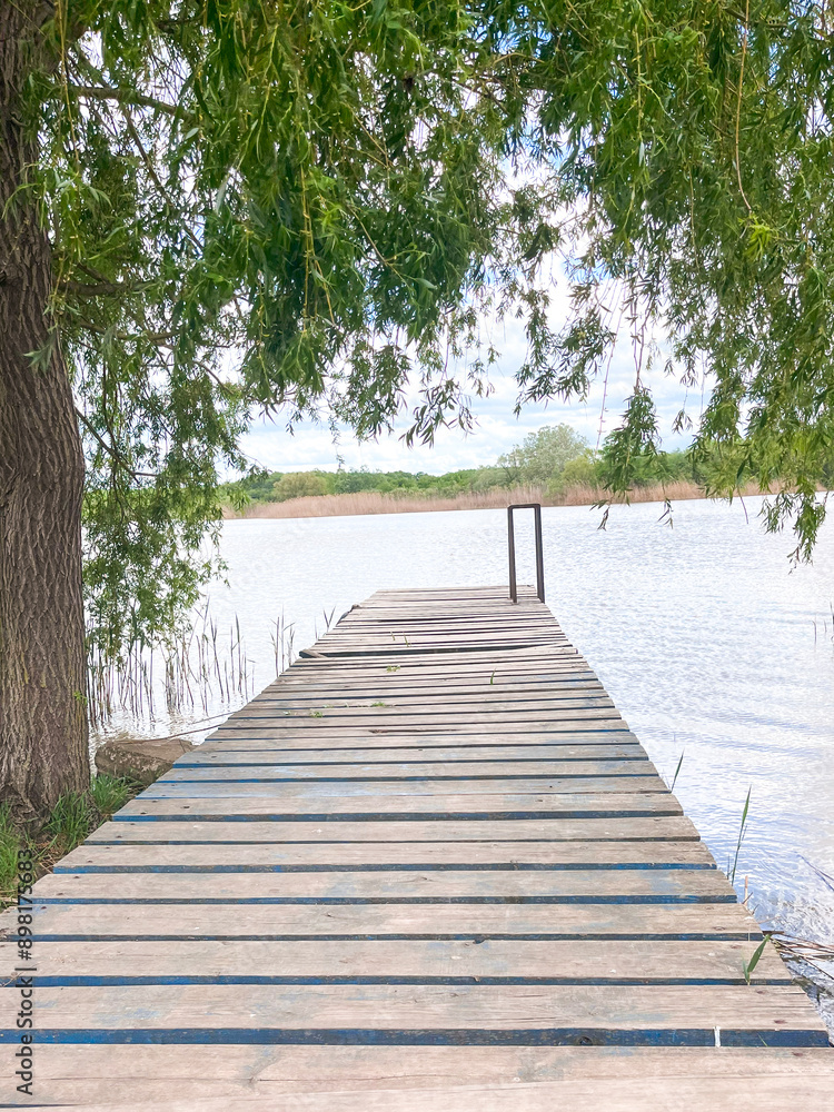 Fototapeta premium River wooden pier. View of the river from a wooden pier