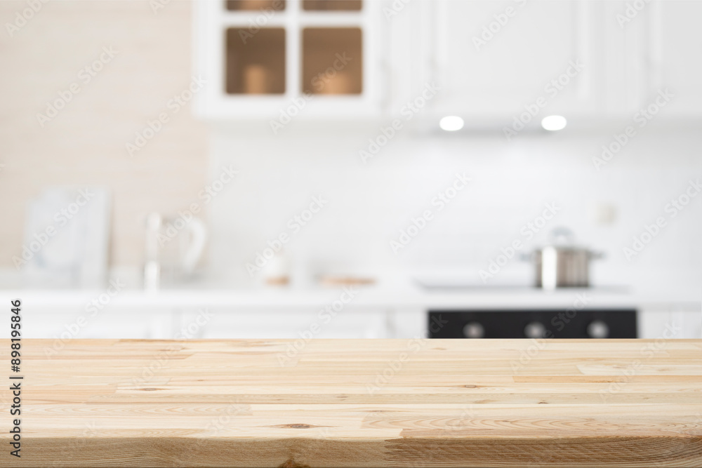 Wooden table top on white and bright modern kitchen interior background Wooden table top on white and bright modern kitchen interior background