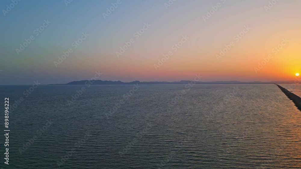 Aerial drone view of infinite road and salt water lake on both sides in Kutch, Road to heaven during sunset Gujarat, India 4K Aerial drone view of infinite road and salt water lake on both sides in Kutch, Road to heaven during sunset Gujarat, India 4K