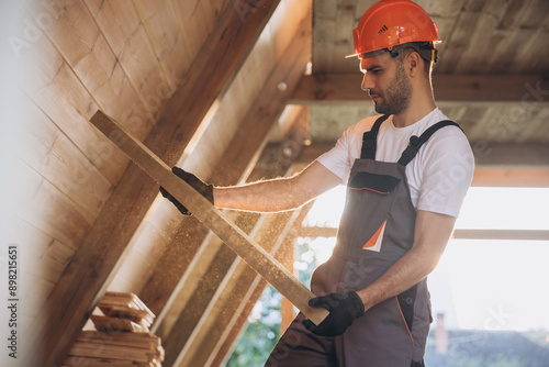 Process of construction new and modern modular house. Worker man in special protective uniform wear working on building development industry of energy efficient property.