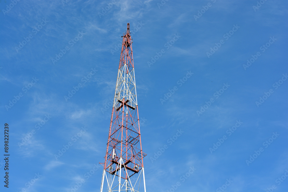 A large metal TV tower against a blue sky. A large metal TV tower against a blue sky.
