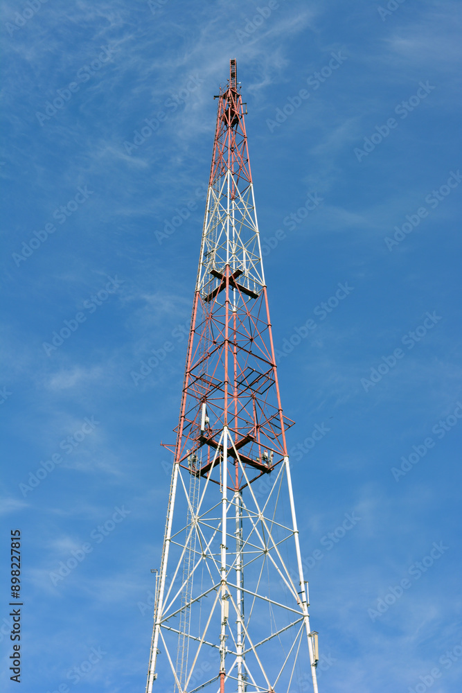 A large metal TV tower against a blue sky. A large metal TV tower against a blue sky.