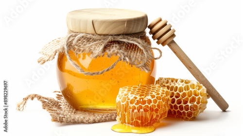 glass_jar_of_honey_with_wooden_lid_honeycomb_and_wooden_dipper_burlap_tied_rustic_style_white_background_isolated_16x9