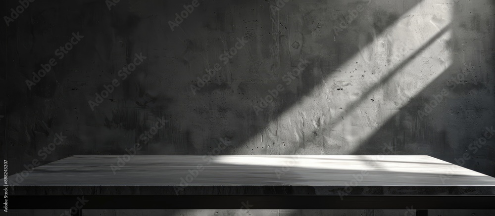 A desk with ample blank space to showcase your product set against a wall casting shadows ideal for a copy space image A desk with ample blank space to showcase your product set against a wall casting shadows ideal for a copy space image