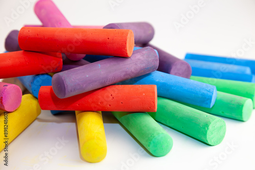 Set of colorful chalks for the board and the street. Drawing chalk stick, back to school background. Heap draw equipment.