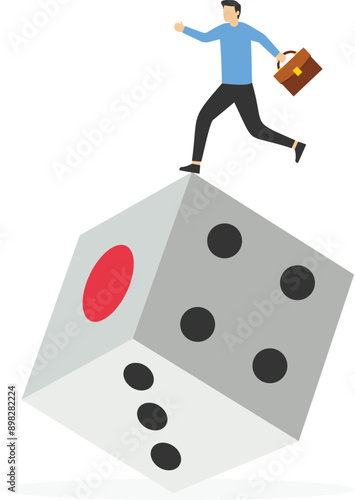 
Business risk and luck concept, businessman balanced on unstable dice

