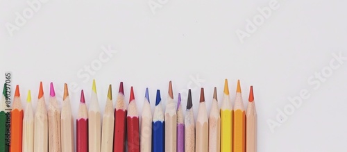 Color pencils stand out on a white backdrop detailed in a close up shot with a very limited focus set against a blank copy space image photo