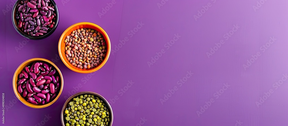 Colorful beans in ceramic bowls on purple backdrop with trendy lighting offering copy space image for a raw healthy ingredient for cooking Colorful beans in ceramic bowls on purple backdrop with trendy lighting offering copy space image for a raw healthy ingredient for cooking