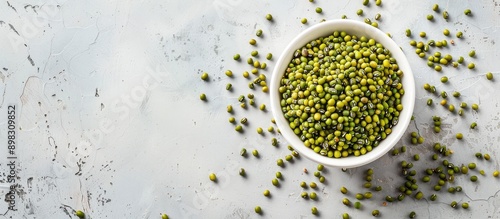 A bowl filled with mung beans or green gram seeds on a white backdrop ideal for a copy space image photo