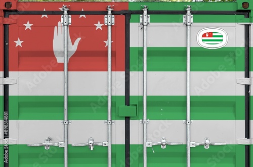 Abkhazia flag depicted on metal doors of shipping cargo container outdoors in docks area close up photo