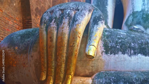 Giant Statue of A Seated Buddha With Tapered Fingers Covered With Gold
Finger of Phra Ajana at Wat Si Chum, in Sukhothai historical park, Sukhothai
The most Beautiful Finger Buddha statue. photo