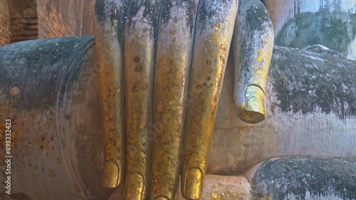 Giant Statue of A Seated Buddha With Tapered Fingers Covered With Gold
Finger of Phra Ajana at Wat Si Chum, in Sukhothai historical park, Sukhothai
The most Beautiful Finger Buddha statue. photo