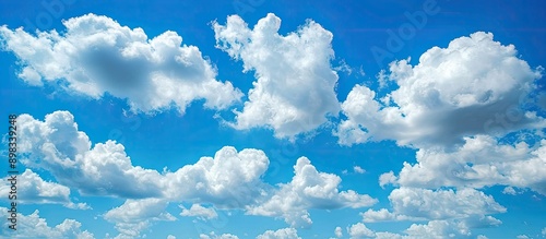 Clear blue sky with fluffy white clouds offering a serene backdrop for any copy space image