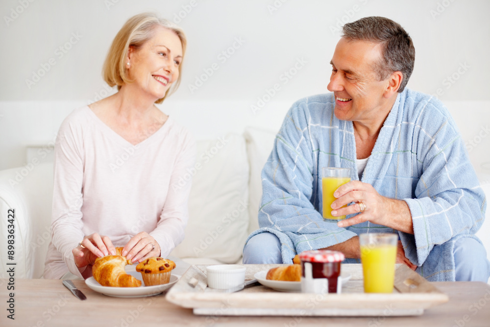 Mature couple, happy and breakfast together on sofa with bonding, diet nutrition and support in home. Smile, man and woman with morning meal, healthy food and romantic time for love relationship Mature couple, happy and breakfast together on sofa with bonding, diet nutrition and support in home. Smile, man and woman with morning meal, healthy food and romantic time for love relationship