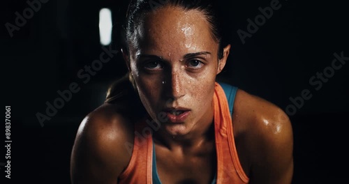 Super slow motion close up of sweat female athlete is relaxing and breathing on a break from doing workout to maintain healthy lifestyle and bodybuilding fitness goals in a gym at 1000 fps.