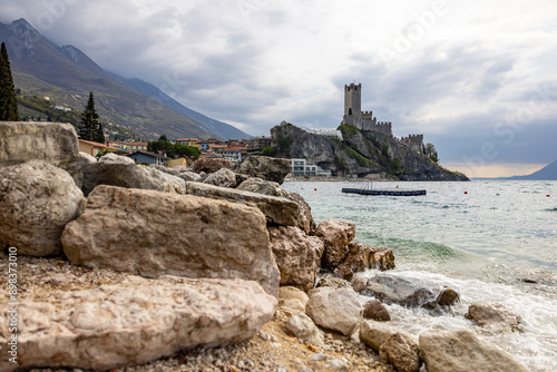 rocks in foreground with caste in background at a lake