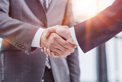 Building a strong business network. two businessmen shaking hands in a modern office.