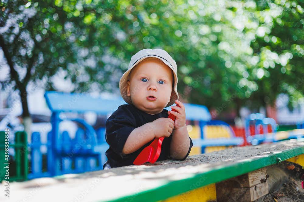 A baby boy in a panama on his head is playing on the playground. A child walking on the street. A baby boy in a panama on his head is playing on the playground. A child walking on the street.