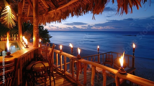 Romantic beach bar with tiki torches at sunset. photo