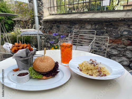 burger and carbonara pasta with drinks in the garden