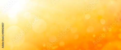 Obraz na płótnie A hot summer sky background with warm golden orange and yellow blurred field, foliage.. w salonie
