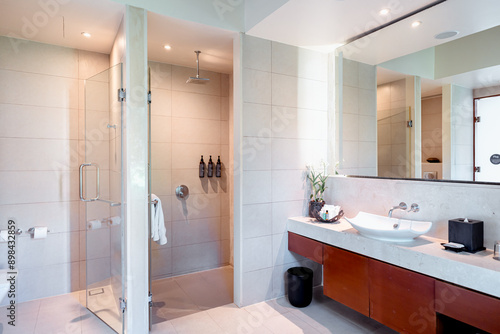Modern White Bathroom Design with Freestanding Bathtub. Light shine through from a side.