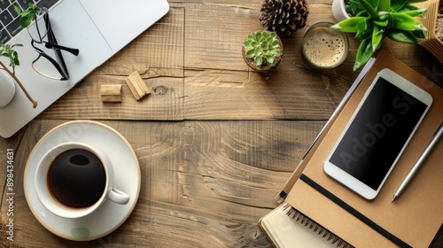 Flat lay, top view office table desk. Freelancer workplace with cup of coffee, paper notebook, office supplies and smartphone screen mockup