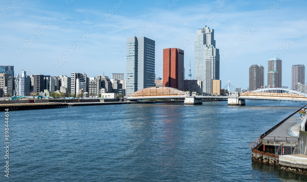 Tokyo city skyline, waterfront skyscrapers against blue sky, Japan capital cityscape Tokyo city skyline, waterfront skyscrapers against blue sky, Japan capital cityscape