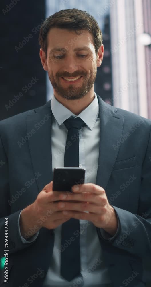 Vertical Video: a Caucasian Businessman in a Suit Walks Through a Bustling City, Smiling While Using His Smartphone, Modern Urban lifestyle, Digital Communication, and Professional Charm Vertical Video: a Caucasian Businessman in a Suit Walks Through a Bustling City, Smiling While Using His Smartphone, Modern Urban lifestyle, Digital Communication, and Professional Charm