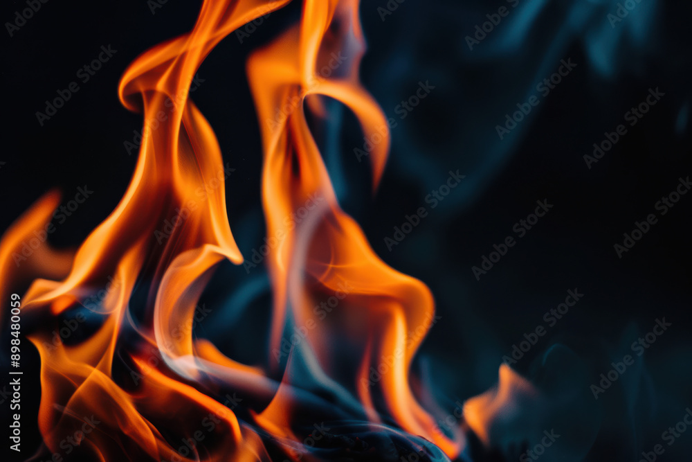 Vivid close-up of intertwined orange and blue flames against a dark background, capturing the dynamic and intense beauty of fire in motion. Vivid close-up of intertwined orange and blue flames against a dark background, capturing the dynamic and intense beauty of fire in motion.