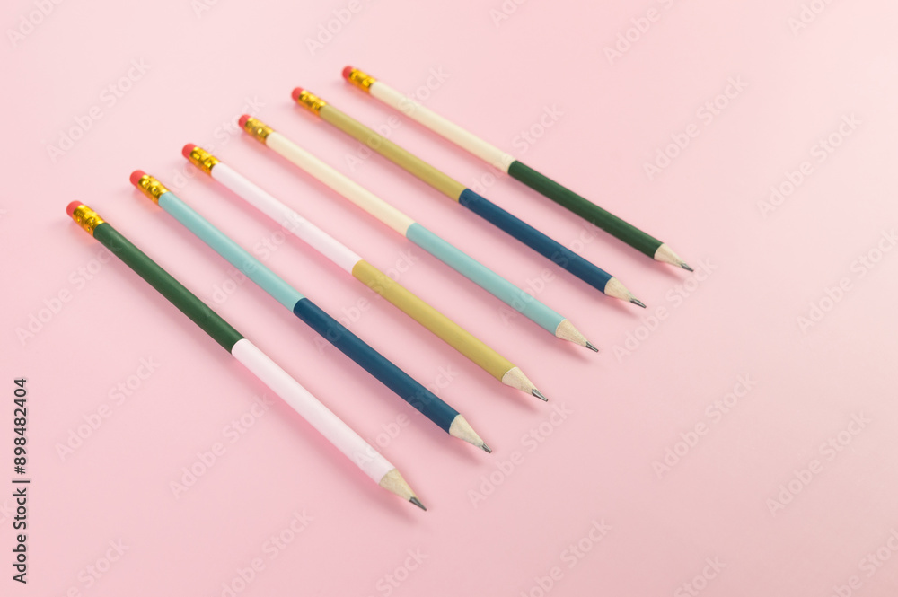 Top view of colorful pencils on pink background. School, office, art wallpaper. Flat lay, copy space. Top view of colorful pencils on pink background. School, office, art wallpaper. Flat lay, copy space.