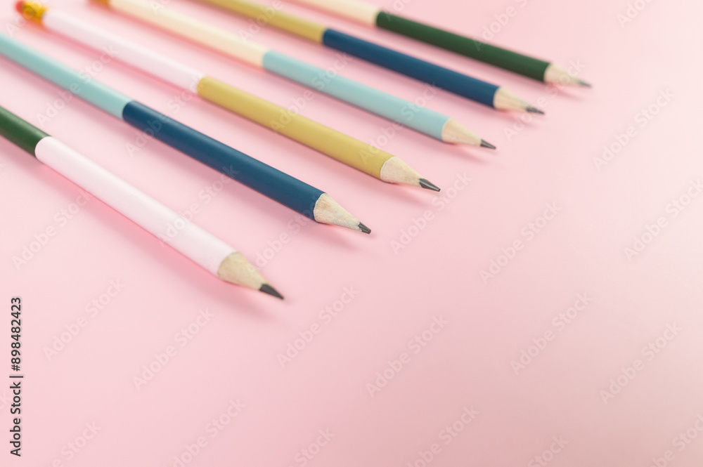 Top view of colorful pencils on pink background. School, office, art wallpaper. Flat lay, copy space. Top view of colorful pencils on pink background. School, office, art wallpaper. Flat lay, copy space.