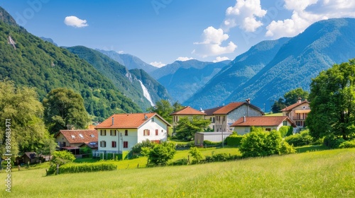 A charming village in the Swiss Alps with traditional wooden houses, lush green meadows, and a stunning waterfall cascading down the mountainside © lililia