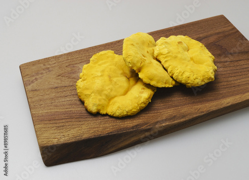 Close-up of three dried raw yellow mushrooms of Phellinus linteus on wood cutting board, South Korea
 photo