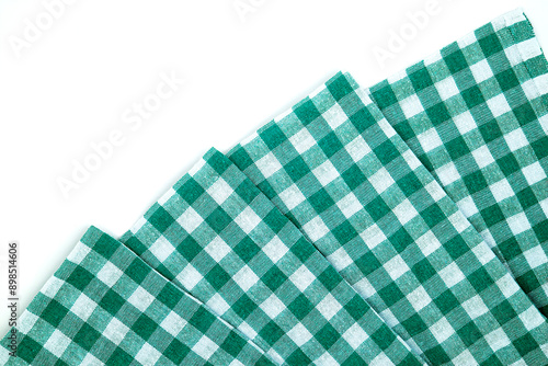 Photo of a traditional tablecloth in green and white and checkered.