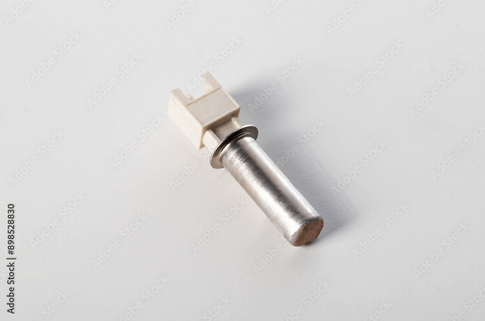 Electric temperature sensor for heating water in a washing machine on a white background, isolate, close-up Electric temperature sensor for heating water in a washing machine on a white background, isolate, close-up