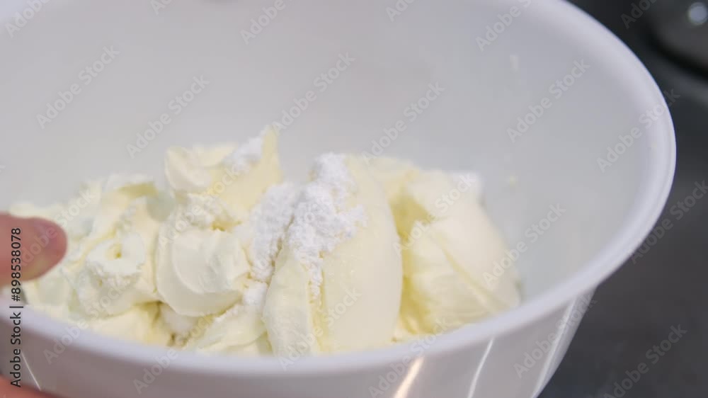 Spreading cream cheese on bagel macro. Whisk cream cheese Spreading cream cheese on bagel macro. Whisk cream cheese