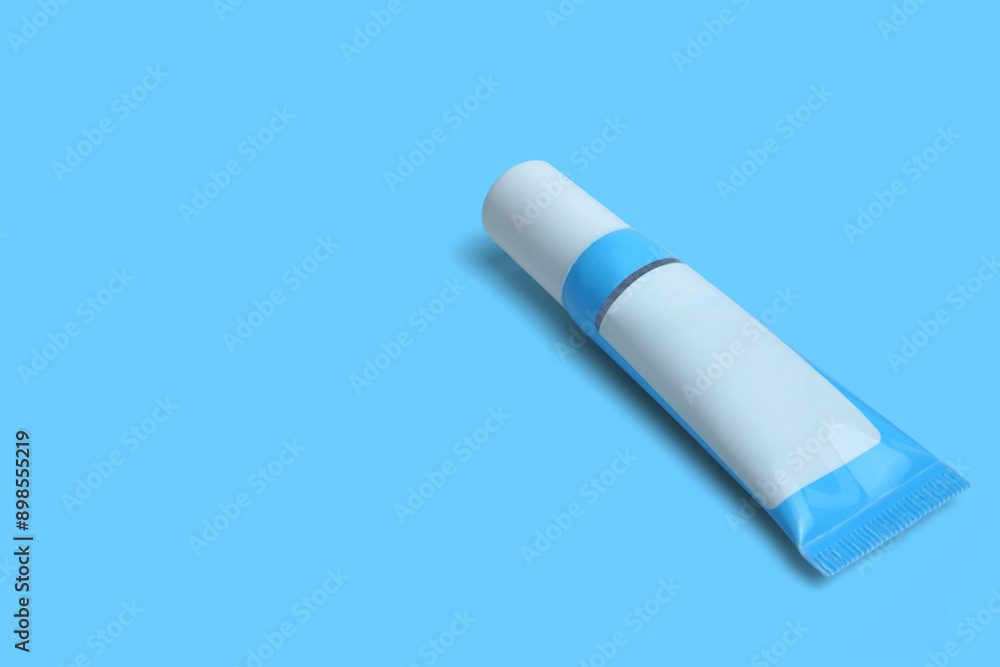blue plastic skincare cream tube isolated on blue background. Clipping path. blue plastic skincare cream tube isolated on blue background. Clipping path.