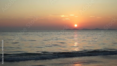 The peaceful sea with beautiful twilight sky in background. Golden sky with the horizontal line of seascape. Explosion of sunlight in the evening sky during the sunset