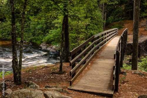 The boardwalk bridge crosses over Pike River within Dave's Falls Marinette County Park, Amberg, Wisconsin in early July