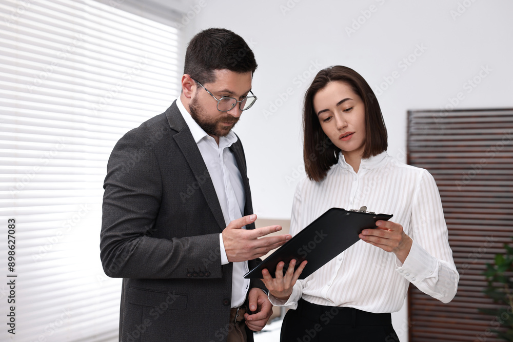Young consultant working with client in office Young consultant working with client in office