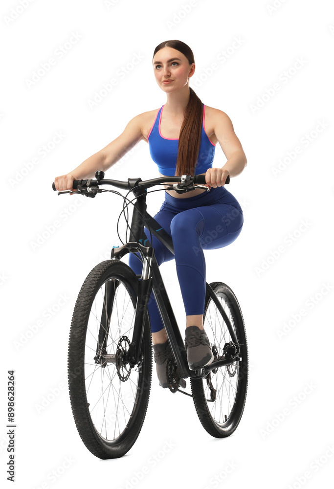 Naklejka premium Beautiful young woman riding bicycle on white background