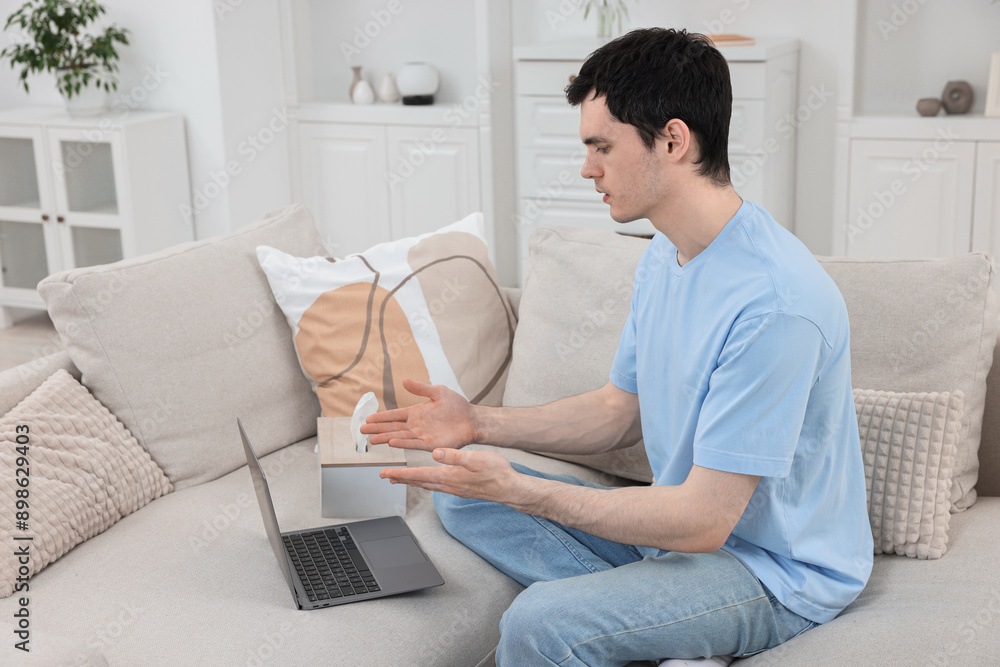Sick man having online consultation with doctor via laptop at home Sick man having online consultation with doctor via laptop at home