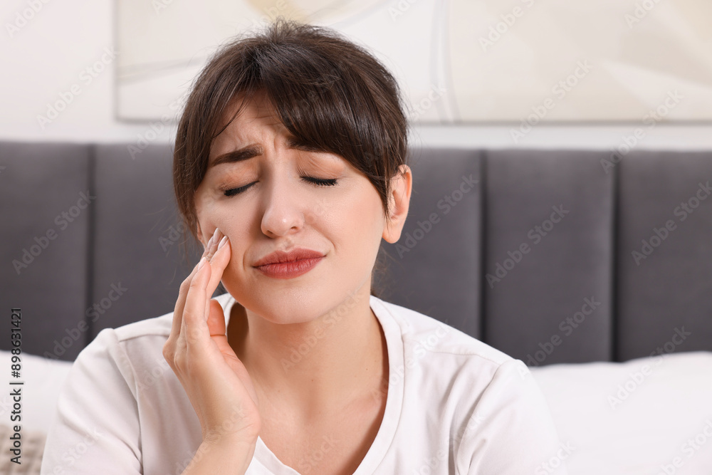 Upset young woman suffering from toothache indoors Upset young woman suffering from toothache indoors