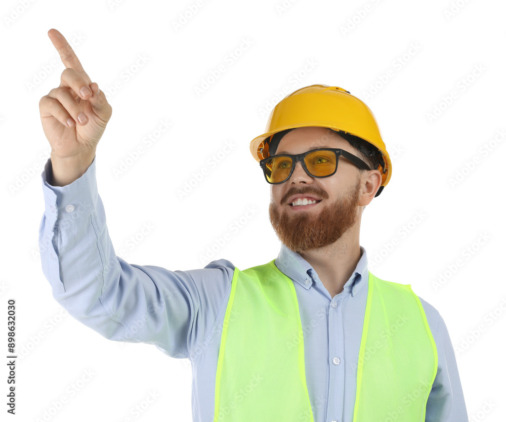 Engineer in hard hat and protective glasses pointing at something on white background Engineer in hard hat and protective glasses pointing at something on white background
