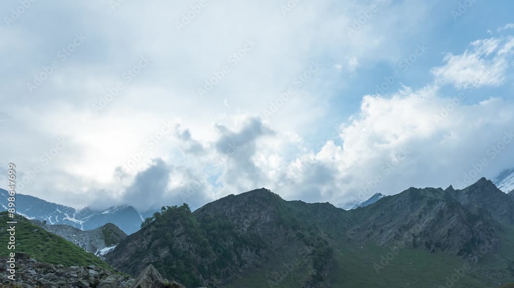 4K timelapse of clouds moving over scenic mountains at Bakarthatch, Himachal Pradesh, India. Nature landscape. Epic nature views during Beas Kund Trek in summer. 4K timelapse of clouds moving over scenic mountains at Bakarthatch, Himachal Pradesh, India. Nature landscape. Epic nature views during Beas Kund Trek in summer.